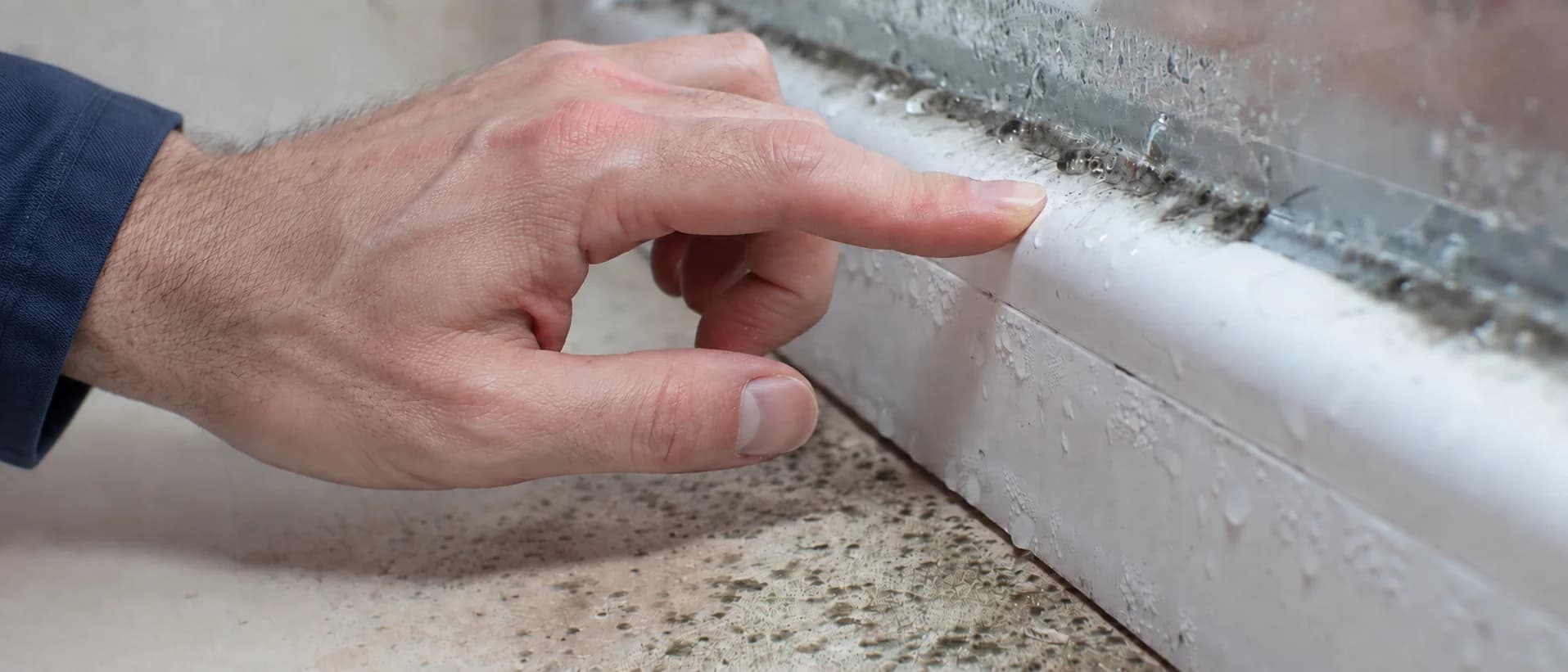 Illustration of a hand pointing to mould and condensation around a window frame.